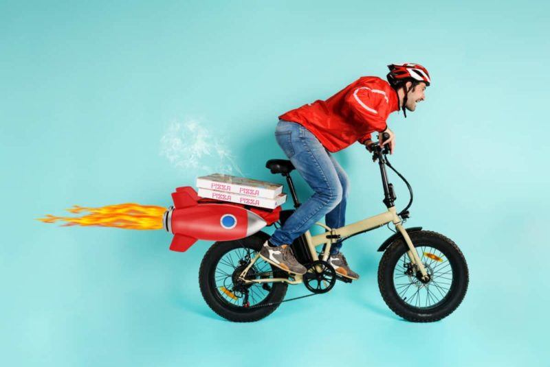A delivery man riding a fast foldable e-bike